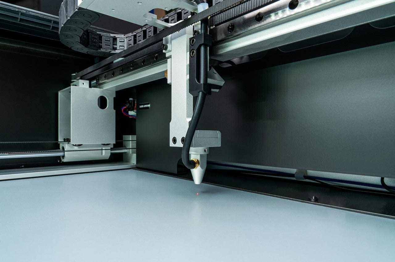 The FSL Muse Core Desktop CO2 Laser Cutting and Engraving Machine, showing the laser cutting lens.