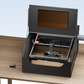 AlgoLaser Smart Enclosure for All Laser Engraving Machines on a table with a laser engraver.