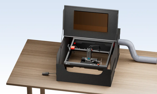 AlgoLaser Smart Enclosure for All Laser Engraving Machines on a table with a laser engraver.