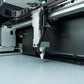 The FSL Muse Core Desktop CO2 Laser Cutting and Engraving Machine, showing the laser cutting lens.