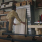 A man in a workshop using the automatic pass-through on the xTool S1 - Enclosed Diode Laser Cutter 40W.